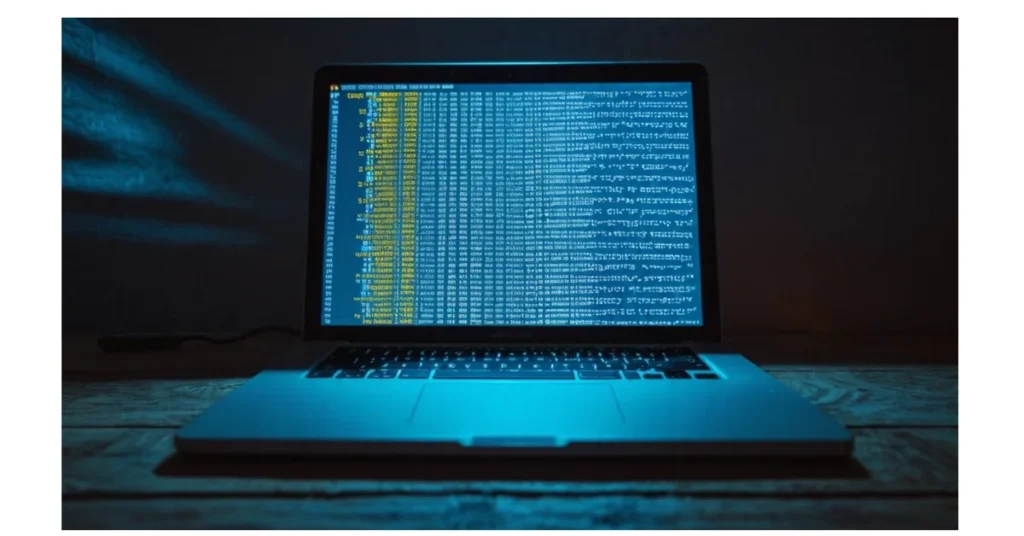 An open laptop displaying lines of code with digital locks and keys.