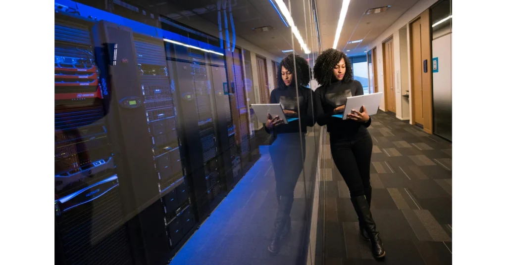 Person with computer in a data center