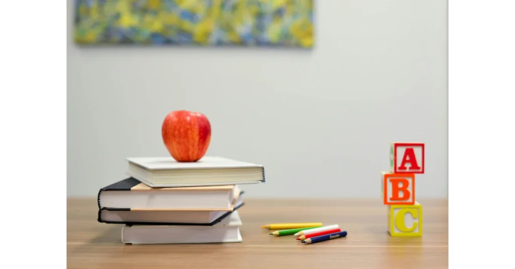 Education Desk With Books and an Apple